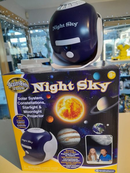 A night sky solar system projector toy sitting on top of its display box