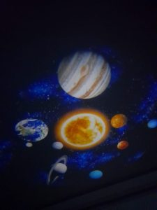 A projected image of our sun surrounded by the planets of our solar system